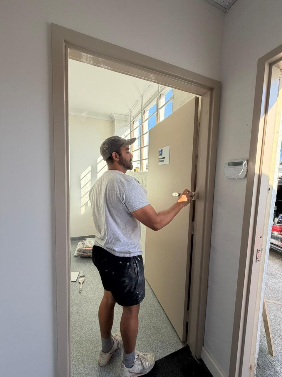 Professional painter at work - door painting project